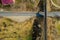 Railway bridge among green meadows over the road in the countryside, aerial view