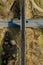 Railway bridge among green meadows over the road in the countryside, aerial view