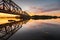 Railway bridge of steel construction in the light of the setting sun