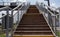 Railway bridge with steps, with impressive steps in perspective. Overhead pedestrian crossing. Bridge stairs connecting one