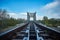 Railway Bridge view. Railroad Path leading into the distance of the blue sky.