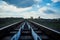 Railway Bridge view. Railroad Path leading into the distance of the blue sky.