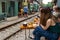 Railway cafe. People drink coffee waiting for train to arrive on railway road in Hanoi, Vietnam