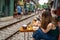 Railway cafe. People drink coffee waiting for train to arrive on railway road in Hanoi, Vietnam