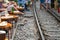 Railway cafe. People drink coffee or walking on railways waiting for train to arrive on railway road in Hanoi, Vietnam