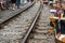 Railway cafe. People drink coffee or walking on railways waiting for train to arrive on railway road in Hanoi, Vietnam. Soft focus