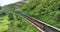 Railway cargo train wagon rides on railroad. Transportation and delivery of cargo in containers. Aerial view over train