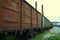 Railway cars are at an impasse in front of the old plant on the background of pipes. Industrial landscape