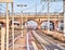 Railway with catenaries crossing a bricks bridge in an European train station