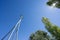 Railway catenary against a blue sky and sun