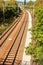 Railway corridor on the Tisnov - Brno route near the town of Kurim in the Czech Republic. Electrified railway line. Train tracks.