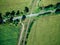 Railway crossing country track in the middle of green field