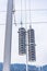 Railway electrification system details- electric power overhead line, steel pylon close up against cloudy, blue sky