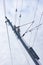 Railway electrification system details- electric power overhead line, steel pylon close up against cloudy, blue sky