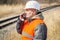 Railway employee talking on cell phone near railway