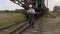 Railway employee talking on phone near the old railway machinery