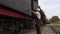 Railway employee talking and walking near locomotive