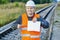 Railway Engineer with open empty book at outdoor on railway