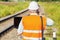 Railway Engineer using smartphone and laptop on railway