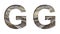 Railway font. The letter G is cut out of white paper against the background of railroad rails, mirror background for convenience.