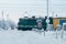 Railway grade cross with passing train, winter season. Car waiting for driving