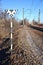 Railway landscape. Railroad sign with the sunny railway background and brightly blue sky