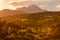 Railway line between the hills in Besenova village, mountain landscape at sunset with a view of Velky Choc peak