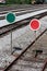 Railway lollipop like signs in green-white and red-white colors mounted on rusted metal poles