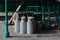 Railway milk churns on station platform.