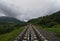 Railway in the mountains. Mountains in clouds. Journey begins