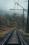 Railway in the mountains. Railroad tracks in autumn mountains. Railroad in foggy morning landscape. Transportation industry