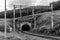 Railway, path with a tunnel in hills with trees, wire pillars, clouds in sky