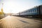 Railway platform and a train in the sun backlight