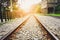 Railway, railroad, train tracks on gravel in a rural scene and sunset background, concept of journey