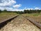 Railway Railroad Transport Way Perspective with Forrest and Cloudy Sky in Background