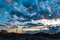 A railway with railway tracks, poles and wires at the dawn of the sun.The heavenly light of the sun.Dramatic evening sky with