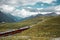 Railway and red train in Gornergrat mountains. Zermatt, Swiss Alps. Adventure in Switzerland.