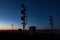 Railway Signal Towers Silhouetted Against Golden Sunset