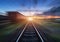 Railway station with cargo wagons in motion blur effect at sunset