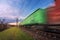 Railway station with cargo wagons in motion at sunset