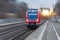 Railway station with head locomotive high speed commuter train with motion blur effect