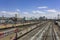 railway station with a lot of trains with cars on the background of modern buildings of the city