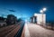 Railway station at night in summer. Starry sky over railroad at dusk