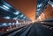 Railway station at night. Train platform in fog. Railroad