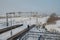 Railway station platform in the snow and a lonely walking passenger