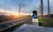 Railway station with semaphore against beautiful sky at sunset