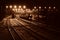 railway station with trains at night in sepia