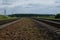 Railway stones at railroad track. Landscape with sky. Outskirts of Vitebsk, Belarus