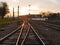 Railway at sunset. Railway station against at sunset. Industrial landscape with a railway. Railway junction. Heavy industry.