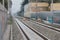 Railway track with graffiti-adorned walls and overhead powerlines